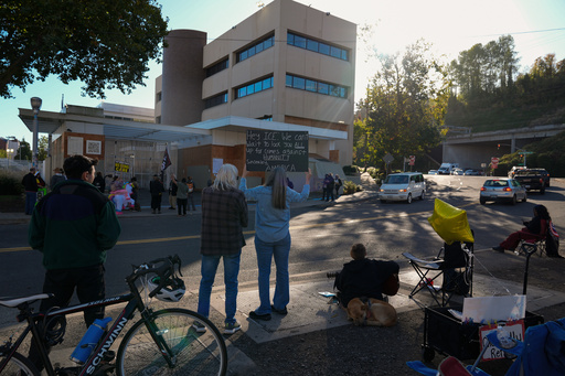 People protest outside a United States Immigration and Customs Enforcement (ICE) facility in Portland, Ore., Monday, Oct. 20, 2025. (AP Photo/Jenny Kane)