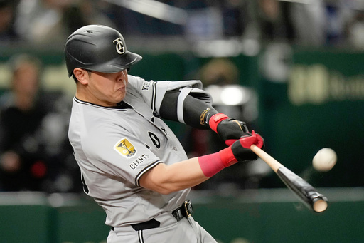FILE - Yomiuri Giants' Kazuma Okamoto flies out in the fourth inning of a spring training baseball game against the Los Angeles Dodgers in Tokyo, Japan, Saturday, March 15, 2025. (AP Photo/Hiro Komae, File)
