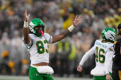 Oregon tight end Roger Saleapaga (83) celebrates a field goal during the first half of an NCAA college football game against Iowa, Saturday, Nov. 8, 2025, in Iowa City, Iowa. (AP Photo/Charlie Neibergall)