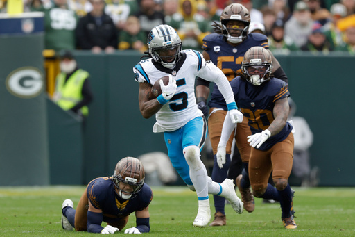 Carolina Panthers running back Rico Dowdle (5) runs for a first down against the Green Bay Packers during the first half of an NFL football game Sunday, Nov. 2, 2025, in Green Bay, Wis. (AP Photo/Matt Ludtke)