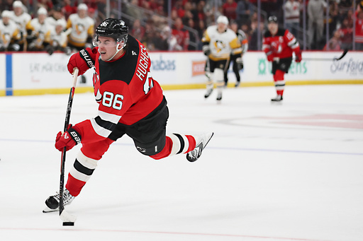 New Jersey Devils center Jack Hughes (86) takes the final shot in overtime of an NHL hockey game against the Pittsburgh Penguins, Saturday, Nov. 8, 2025, in Newark, N.J. (AP Photo/Heather Khalifa)