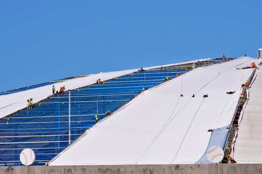 Workers continue to repair the panels on the roof of Tropicana Field Monday, Nov. 3, 2025, in St. Petersburg, Fla. The roof was destroyed by Hurricane Milton in 2024. (AP Photo/Chris O'Meara)