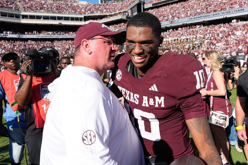 Texas A&M quarterback Marcel Reed (10) celebrates with head coach Mike Elko after an NCAA college football game against South Carolina Saturday, Nov. 15, 2025, in College Station, Texas. (AP Photo/David J. Phillip)
