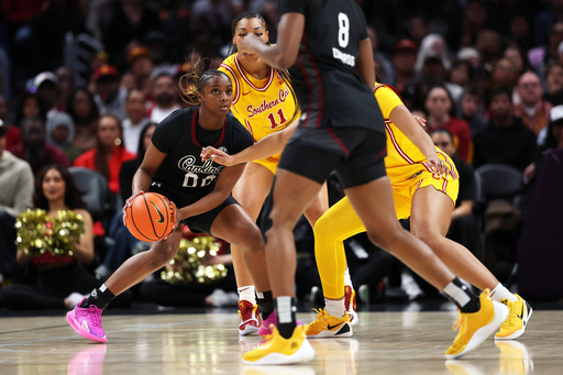 South Carolina guard Ta'Niya Latson, left, looks to pass the ball against Southern California during the first half of an NCAA college basketball game Saturday, Nov. 15, 2025, in Los Angeles. (AP Photo/Allison Dinner)