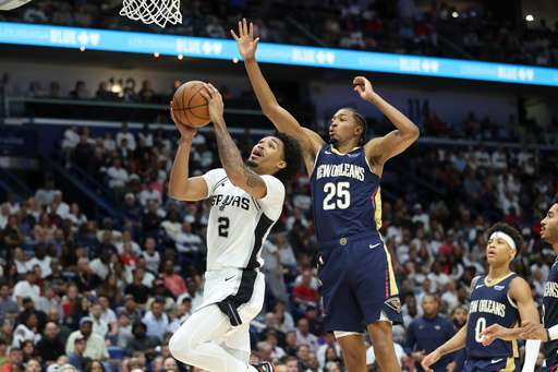 San Antonio Spurs guard Dylan Harper (2) shoots a layup against New Orleans Pelicans forward Trey Murphy III (25) during the second half of an NBA basketball game Friday, Oct. 24, 2025, in New Orleans. (AP Photo/Peter Forest)