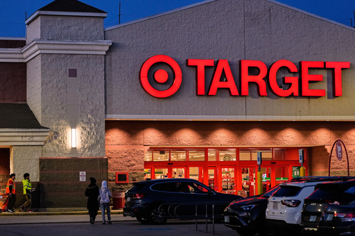 Shoppers walk towards a Target retail store, Tuesday, Nov. 18, 2025, in Salem, N.H. (AP Photo/Charles Krupa)