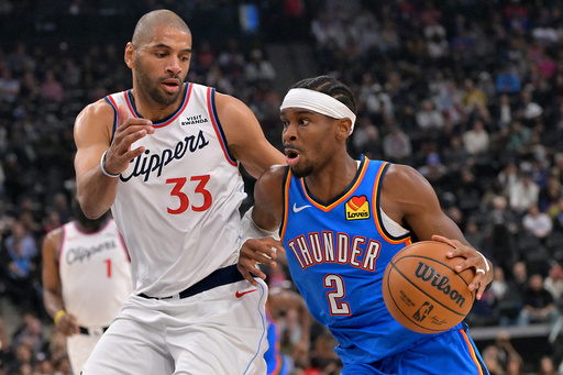 Oklahoma City Thunder guard Shai Gilgeous-Alexander drives past Los Angeles Clippers forward Nicolas Batum during the first half of an NBA basketball game Tuesday, Nov. 4, 2025, in Los Angeles. (AP Photo/Jayne Kamin-Oncea)