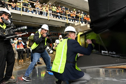 NFL Commissioner Roger Goodell signs a beam during a topping out ceremony to celebrate the ongoing construction of the Tennessee Titans NFL football new stadium, Friday, Nov. 21, 2025, in Nashville, Tenn. (AP Photo/John Amis)