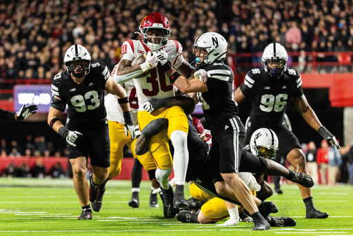 Southern California running back King Miller (30) carries the ball against Nebraska defensive back Rex Guthrie (21) during the second half of an NCAA college football game, Saturday, Nov. 1, 2025, in Lincoln, Neb. (AP Photo/Bonnie Ryan)