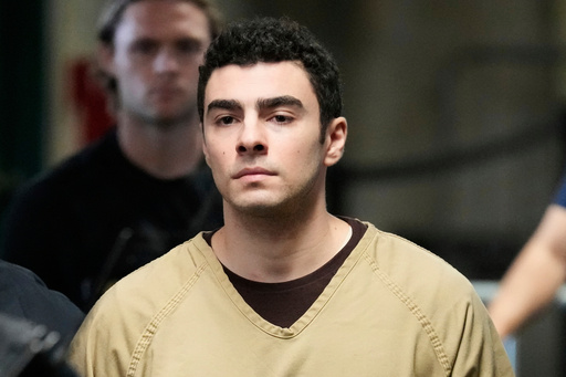 FILE - Luigi Mangione is escorted into Manhattan state court in New York, Sept. 16, 2025. (AP Photo/Seth Wenig, file)