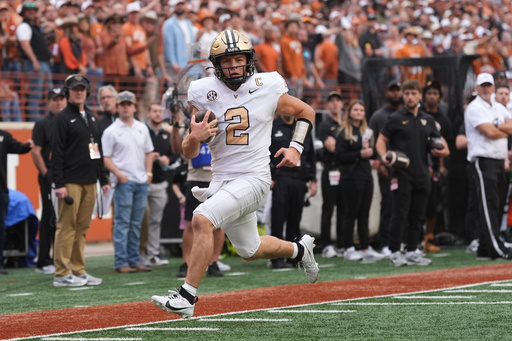Vanderbilt quarterback Diego Pavia (2) scores a touchdown against Texas on a run during the second half of an NCAA college football game in Austin, Texas, Saturday, Nov. 1, 2025. (AP Photo/Eric Gay)