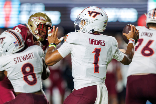 Virginia Tech quarterback Kyron Drones (1) looks to pass against Florida State during the first half of an NCAA college football game, Saturday, Nov. 15, 2025, in Tallahassee, Fla. (AP Photo/Colin Hackley)